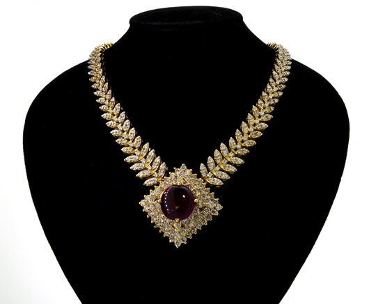 7.90-carat cabochon ruby pendant-style 14K yellow gold necklace, est. $18,000-$36,000. Government Auction image.