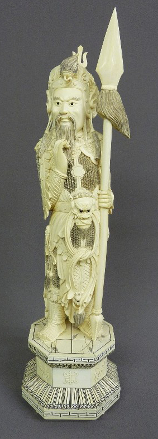 Fine 26-inch Chinese carved ivory warrior/deity in full 'woven mail' body armor, with intricate headdress, holding spear, wearing a death mask and belt buckle. Estimate $3,000-$5,000. Image courtesy of Jay Anderson Antique Auction.