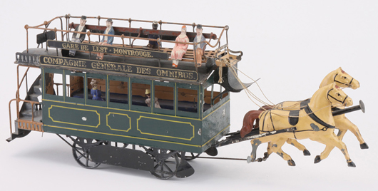 French horse-drawn tin omnibus floor toy emblazoned with “Compagnie Generale Des Omnibus” and “Gare d l’Est – Montrouge,” $11,500. Noel Barrett Auctions image.