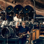 Jerry Garcia playing his guitar 'Tiger' at a Grateful Dead concert at Red Rocks in Colorado. 1987 image by Mark L. Knowles, licensed under the GNU Free Documentation license.