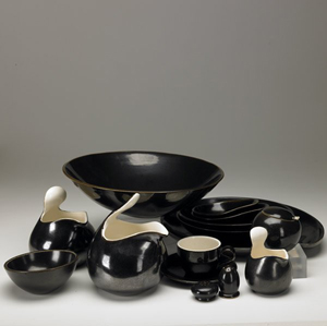 Eva Zeisel's most famous dinnerware line is Town and Country, shown here in a dark brown metallic glaze. Image courtesy of LiveAuctioneers.com and Rago Art and Auction Center.