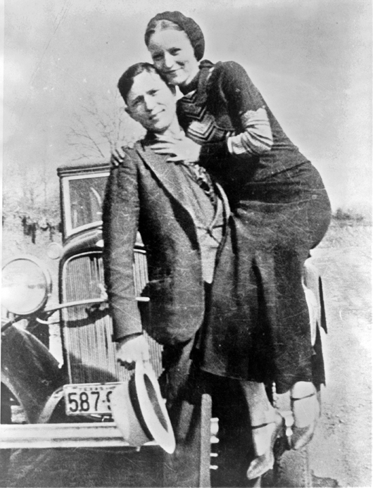Clyde Barrow and Bonnie Parker in a photograph recovered in March 1933 at their hideout in Joplin, Mo. Image courtesy of Wikimedia Commons.