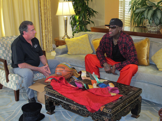 Richard Russek (right), president of Grey Flannel Auctions, visits with basketball Hall of Famer Dennis Rodman during the taping of Discovery's All Star Auctions. Photo by Michael Russek.
