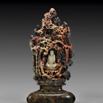 Chinese carved soapstone grotto centering Guanyin on lotus base with two attendants, circa 1900, 15 3/8 inches high. Estimate: $800-$1,200. Image courtesy I.M. Chait Gallery Auctioneers.