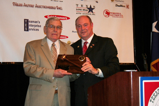 Jack Ogle (left) is presented his Texas Auctioneers Association Hall of Fame plaque in 2010  by Mike Jones. Image courtesy of the Texas Auctioneers Association.