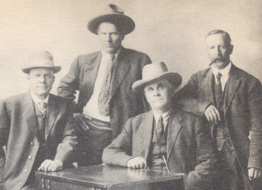 A photo shows Charles M. Russell (second from left) with Dr. John Louis Weitman (far right). Image courtesy of Clars Auction Gallery.
