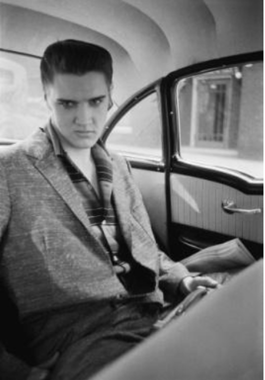 Inside Taxi, With his RCA portable transistor 7 radio blasting away in the back of a local cab from the train station, Elvis is about to leave for the Jefferson Hotel. He has two performances at the Mosque Theater (now the Landmark Theater) that afternoon and evening. Richmond, Va., June 30, 1956 © Alfred Wertheimer. All rights reserved.