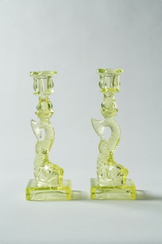 Dolphin candlesticks by Boston and Sandwich Glass Co. are favorites of early American glass collectors. These canary-colored candleholders are 10 1/2 inches high and have a $1,000-$1,500 estimate. Image courtesy of Keno Auctions.