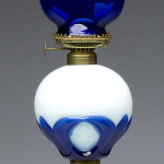 Nineteenth-century Tulip and Star stand lamp in an opalescent and cobalt blue font. October sale: $5,462. Image courtesy of Jeffrey S. Evans & Associates.