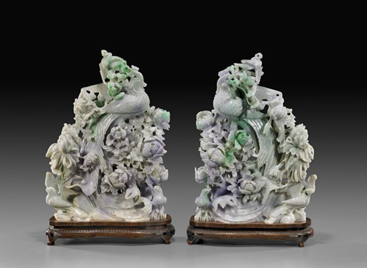 Pair of magnificently openwork carved Chinese jadeite groups of phoenix, each approximately 14 inches high, wire inlaid wood stands. Estimate: $25,000-$30,000. Image courtesy of I.M. Chait.