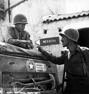 In this 1943 photo taken near Brolo, Sicily, Lt. Gen. George S. Patton (left) discusses the second daring amphibious landing behind enemy lines on Sicily's northern coast with Lt. Col. Lyle Bernard, who was Commanding Officer of the 30th Infantry Regiment. This U.S. Army Signal Corps photo is currently in the collection of the National Archives and Records Administration.