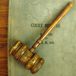 Auctioneer's gavel with bound book of 1862 court minutes displayed at the Minnesota Judicial Center. Photo by Jonathunder, licensed under the Creative Commons Attribution-Share Alike 3.0 Unported, 2.5 Generic, 2.0 Generic and 1.0 Generic licenses.
