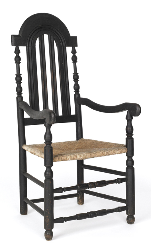 A William and Mary armchair, circa 1735, sold for $28,440. This early Chester County or southeastern Pennsylvania example had a baluster back and old black painted surface with punched star decorations. Image by Pook & Pook Inc.