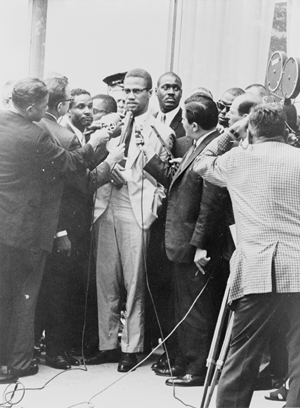 Malcolm X (center) at a 1964 press conference. Photo by Herman Hiller, New York World Telegram staff photographer, Library of Congress, New York World-Telegram & Sun Collection.