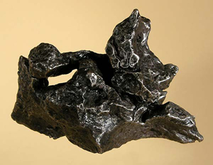 Campo del Cielo (Argentina) iron meteorite with natural hole, 576 grams. Geoffrey Notkin copyrighted photo licensed under the Creative Commons Attribution-Share Alike 2.5 Generic license.