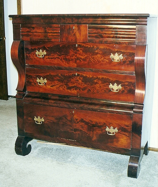 The 18th-century Chippendale-style reproduction drawer pulls are completely inappropriate for this Late Classicism chest, circa 1840. The pulls should be round wooden or glass knobs. Photo courtesy of Turkey Creek Auction, Citra, Fla.   