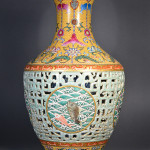 Chinese Qing Period porcelain vase, reticulated design, with an inset medallion depicting auspicious waves in front of crashing waves; above and below the geometric dragon band features foreign lotus scrolls borne on lobed-tipped branches; flared rim decorated with a narrow meander register above pendant trefoil shaped heads; six-character Qianlong Mark on base; H: 41 cm, D: 25 cm. Estimate $30,000-60,000. Image courtesy of 888 Auctions.