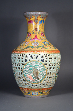 Chinese Qing Period porcelain vase, reticulated design, with an inset medallion depicting auspicious waves in front of crashing waves; above and below the geometric dragon band features foreign lotus scrolls borne on lobed-tipped branches; flared rim decorated with a narrow meander register above pendant trefoil shaped heads; six-character Qianlong Mark on base; H: 41 cm, D: 25 cm. Estimate $30,000-60,000. Image courtesy of 888 Auctions.