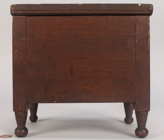 Retaining its original surface and measuring just 6-1/2 inches tall, this little box in the form of a sugar chest brought a big $2,320. Image courtesy of Case Antiques Auction.