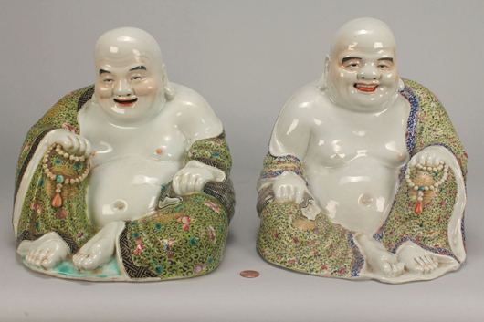 A pair of Famille Rose porcelain Buddha figures sold to an Asian buyer for $11,136. Image courtesy of Case Antiques Auction.