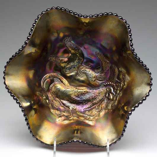 Scarce Dugan Glass Co. Farmyard pattern purple carnival glass bowl, 10 1/2 inches diameter. Estimate: $1,000-2,000. Image courtesy Jeffrey S. Evans & Associates.