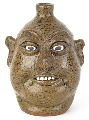 Georgia stoneware face jug by Lanier Meaders, signed on base, 9 1/4 inches high. Image courtesy Pook & Pook Inc.