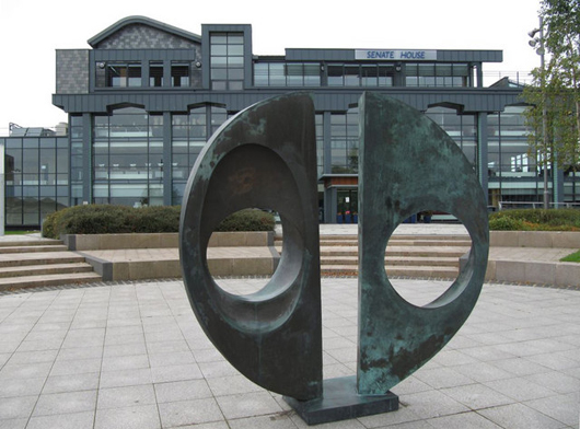 Barbara Hepworth's 1969 sculpture 'Two Forms (Divided Circle)' in front of Bolton University's Senate House, Bolton, England. This sculpture is from the same edition as the one stolen from Dulwich Park, London, and feared to have been melted down for its metal value. Photo by Bill Nicholls, licensed for reuse under the Creative Commons Attribution-ShareAlike 2.0 license.