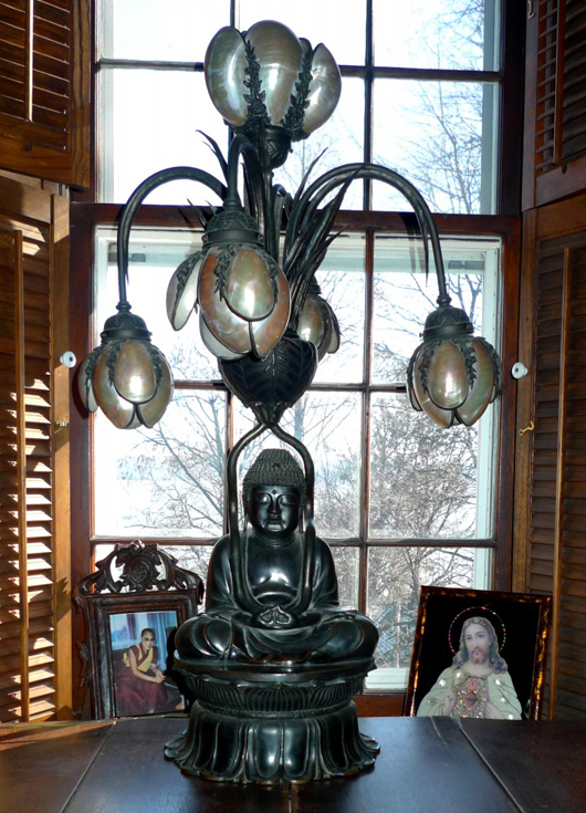 Lamp featuring a bronze statue of Buddha with five globes made of seashells from Thailand. Image by Susan McTigue.