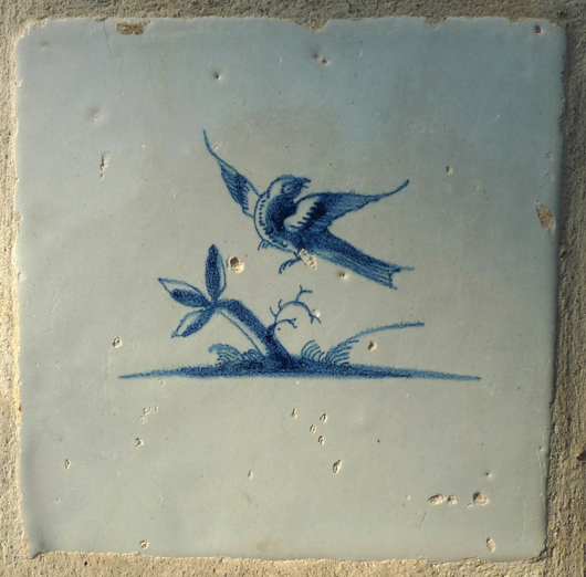A greenhouse added to the home in the 1930s is lined with Delft tiles like this one. Image by Susan McTigue.