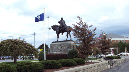 A statue of cavalry soldier Gen. George Armstrong Custer stands at a busy intersection in Monroe, Mich. Image courtesy Wikimedia Commons.