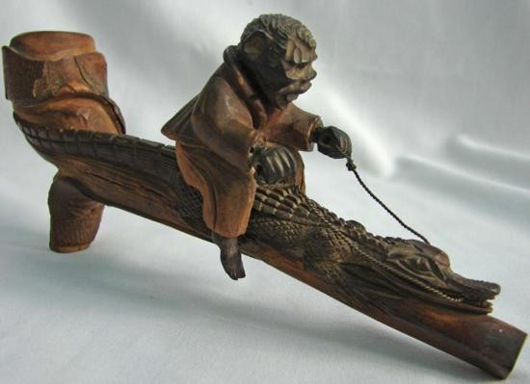 Nineteenth century carved walnut pipe, crafted by a black American in South Carolina. Estimate: $1,725-$2,500. Image courtesy UniversalLive.