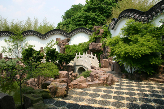 A view of the bridge, rockery and undulating wall at the New York Chinese Scholars Garden at the Staten Island Botanical Garden.