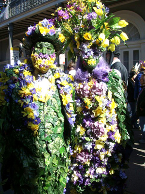 New Orleans Mardi Gras revelers in the French Quarter in 2010, wearing elaborate flower costumes in the traditional local colors of purple, green, and gold.This file is licensed under the Creative Commons Attribution 2.0 Generic license.