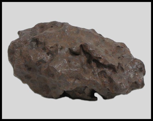 Large meteorite, height 8 inches, length 13 1/4 inches, approximately 110 pounds. Image courtesy William Jenack Estate Appraisers and Auctioneers.