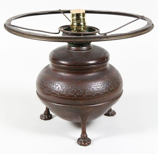 Circa 1902 Tiffany Studio lamp base, bronze, marked ‘Tiffany Studios New York 23542’ on base, three lily pad feet, 11 inches high x 8 inches wide. Originally oil but converted to electric. Estimate: $400-$600. Image courtesy Kaminski Auctions.