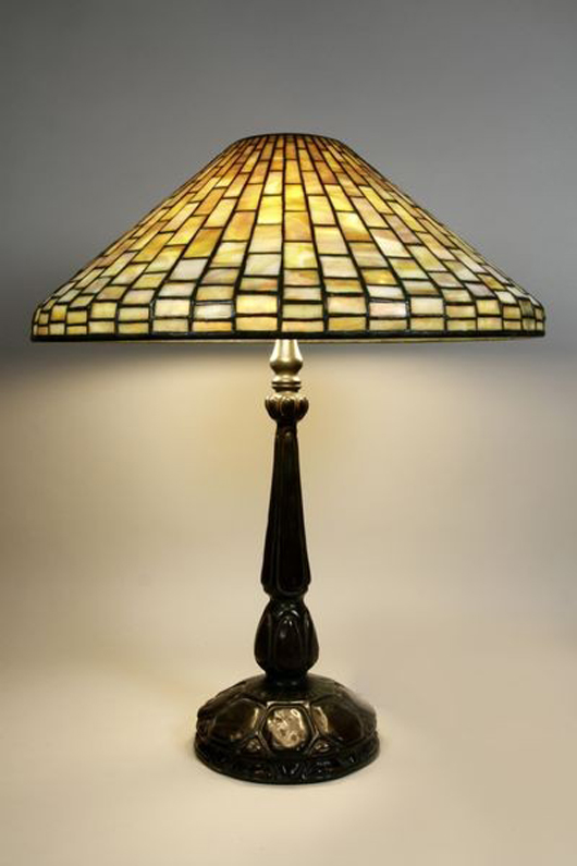 Louis Comfort Tiffany geometric table lamp, bronze turtleback base, signed ‘Tiffany Studios New York #1493’ on shade, ‘Tiffany Studios #587’ on base, 25 inches high, 20 1/4-inch-diameter shade. Estimate $8,000-$12,000. Image courtesy Kaminski Auctions.