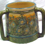 Newcomb College pottery loving cup with rare orange glaze, designed by Leona Nicholson. John W. Coker image.