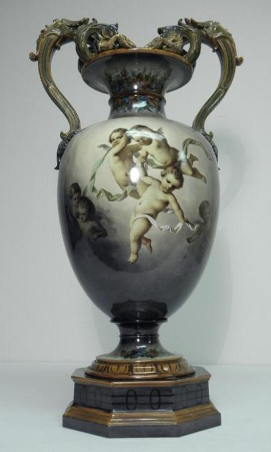 KPM Berlin porcelain hand-painted urn, scene with multiple cherubs, circa 1763-1837, small repair to flower at top, 23 3/4 inches tall by 12 1/2 inches wide. Estimate: $2,500-$3,500. Image courtesy Auctions Neapolitan. 
