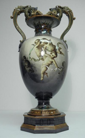 KPM Berlin porcelain hand-painted urn, scene with multiple cherubs, circa 1763-1837, small repair to flower at top, 23 3/4 inches tall by 12 1/2 inches wide. Estimate: $2,500-$3,500. Image courtesy Auctions Neapolitan.