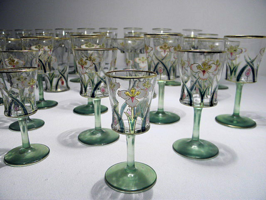 Art Nouveau enameled and gilt crystal stemware, 97 pieces, possibly Theresienthat or Lobmeyer, green and clear glass decorated with gilt and enameled florals, includes 12 4-inch-tall stems. Estimate: $1,800-$2,200. Image courtesy Auctions Neapolitan.  