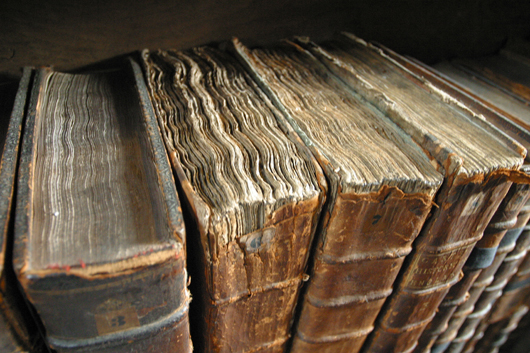 Old books awaiting restoration. Image by Tom Murphy VII. Image courtesy Wikimedia Commons.