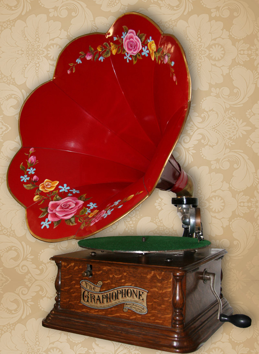 Antique oak phonograph with vivid red morning glory horn. GovernmentAuction.com image.
