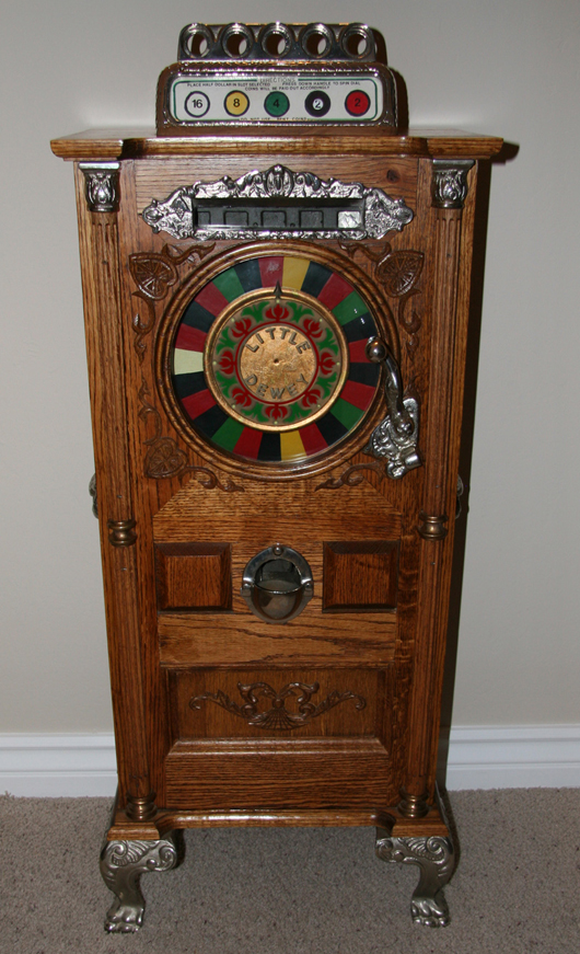 Antique miniature Dewey 50-cent slot machine, one of very few made. GovernmentAuction.com image.