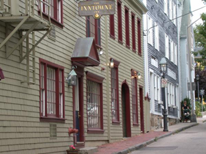 View of antique buildings on Mary Street in Newport, R.I., with the Inntowne Inn, now operating as America's Cup Inn, in foreground. Photo copyright Matthew Trump, 2004, licensed under the Creative Commons Attribution-Share Alike 3.0 Unported license.