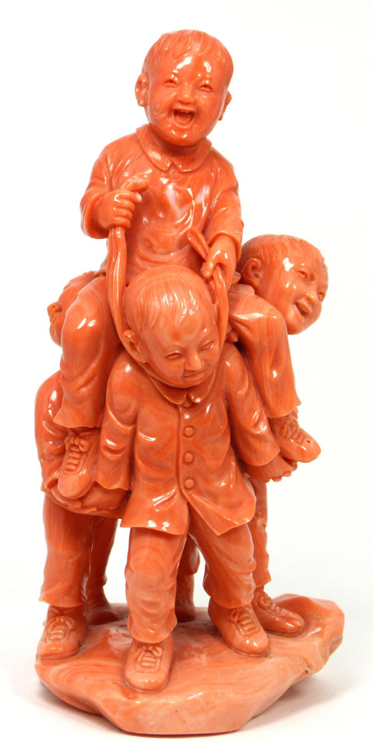 Chinese relief carved coral group figure of children playing around a tree and table. Price realized $14,160). Image courtesy Elite Decorative Auctions.