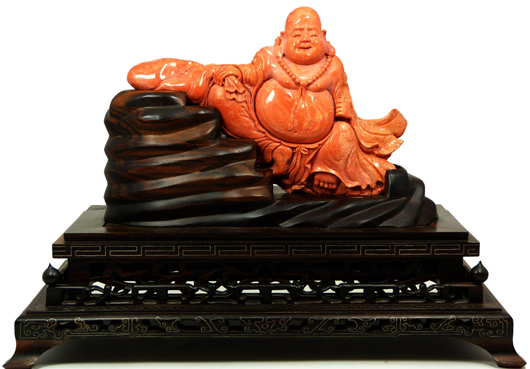 Superb Chinese hand-carved red coral figure depicting a seated happy Buddha. Price realized: $28,750. Image courtesy Elite Decorative Auctions.