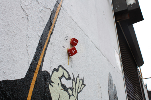 The dice in ‘Grim Tales’ add a 3-D effect to the painting. Painting by D*Face; photography by Kelsey Savage.