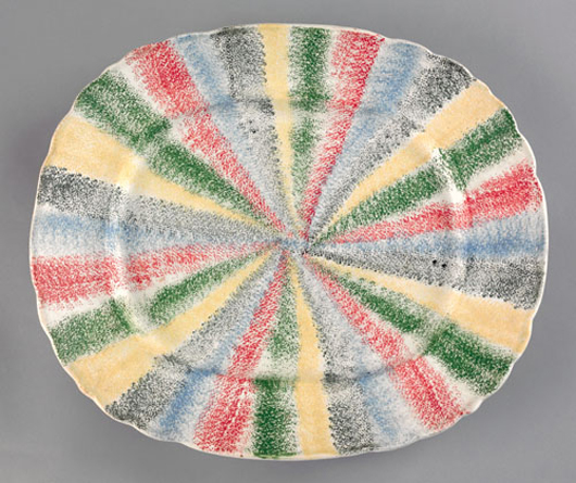 Absolute proof that rarities bring the highest prices, this 13-inch platter decorated with a rainbow of five spatter colors sold for a record $39,780 in April 2009. Courtesy of Pook & Pook