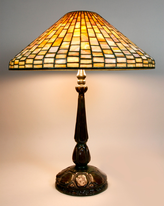 Louis Comfort Tiffany geometric table lamp, signed Tiffany Studios New York no. 1493 on shade, signed Tiffany Studios no. 587 on base, 25 inches high x 20 1/4 inches diameter. Sold for $14,000 Image courtesy Kaminski Auctions.   