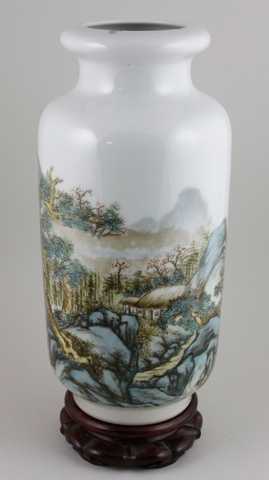 Chinese Republic Period Famille Rose vase, painted with a continuous landscape scene with calligraphy, mark on base, on wood stand, 15 inches x 6 1/2 inches. Sold For $220,000. Image courtesy Kaminski Auctions.   